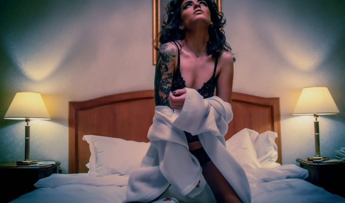 woman kneeling on white mattress